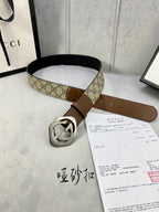 Gucci belt with GG-pattern canvas strap and brown leather, silver-tone buckle detail.