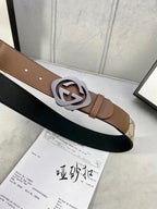 Gucci belt laid flat: GG canvas with brown leather ends and silver-tone interlocking buckle.
