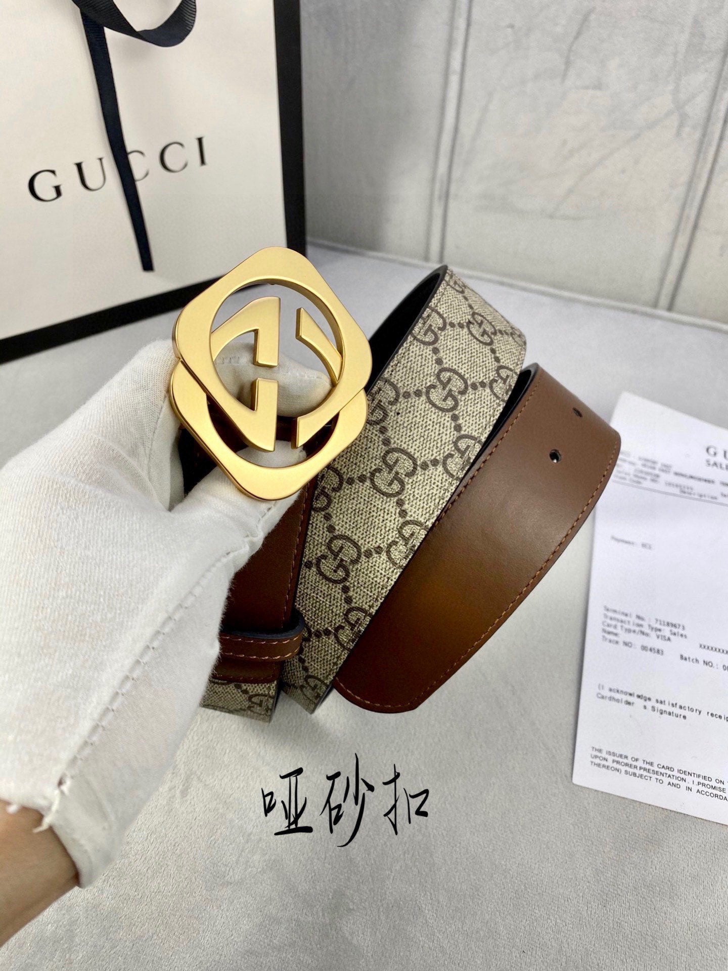 Gucci belt with GG-pattern canvas and brown leather, large gold-tone interlocking buckle.