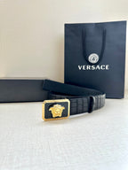 Navy leather belt with embossed finish and gold Medusa buckle centerpiece