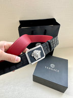 Belt: black with red interior, square Medusa emblem buckle, held in hand.