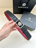 Belt: black leather-style with red underside, square engraved Medusa buckle.
