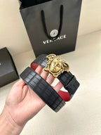 Black leather belt with red lining and gold Medusa head buckle