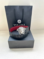 Black leather belt with red lining and silver Medusa medallion buckle
