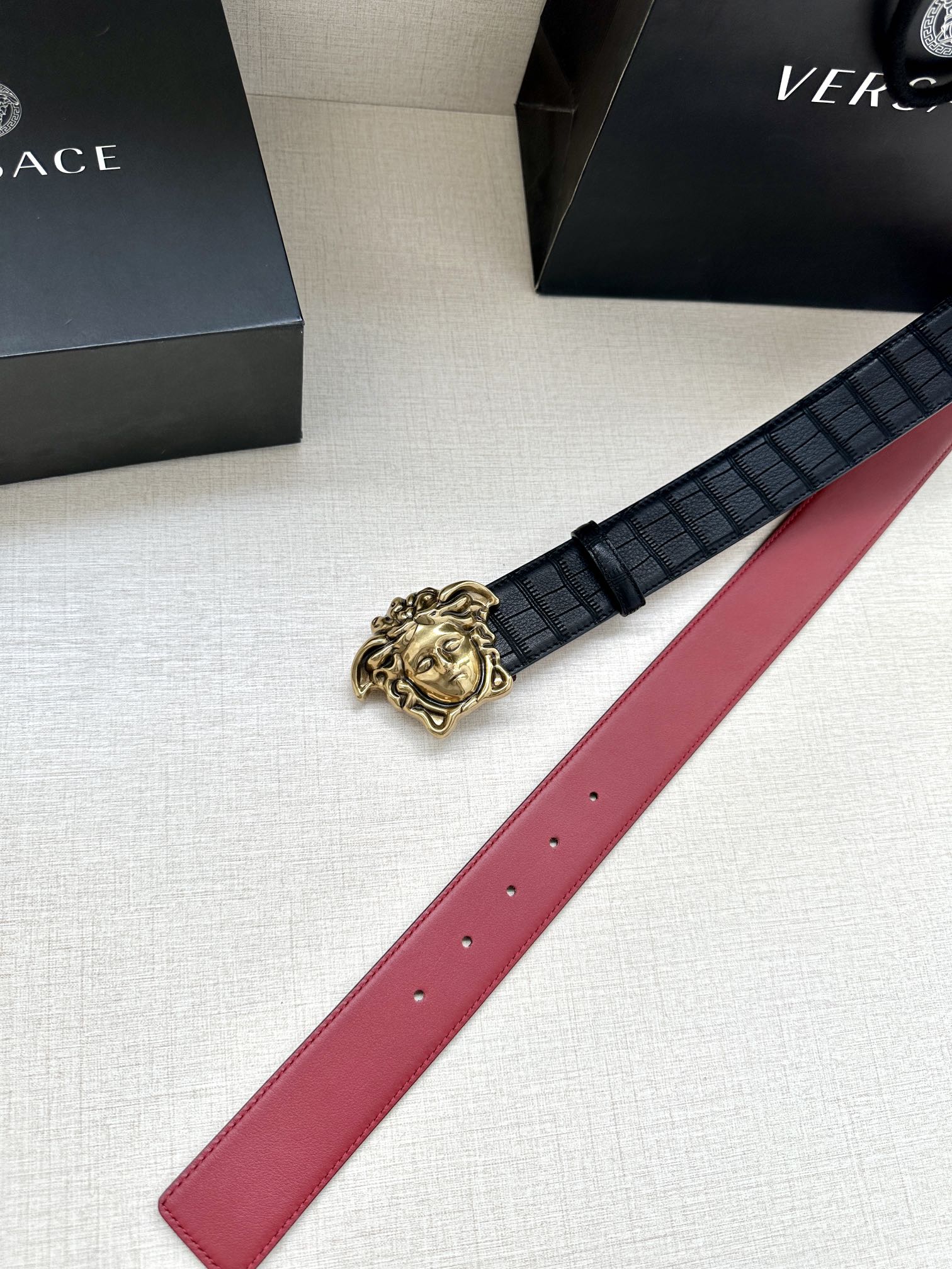 Black leather belt with red strap and gold Medusa buckle detail