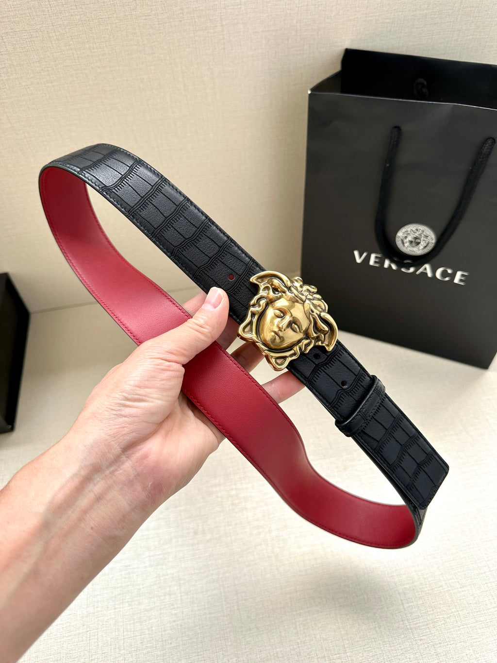 Black leather belt with red lining and gold Medusa buckle
