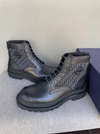 Pair of dark Dior lace-up boots with monogram uppers and thick rubber sole