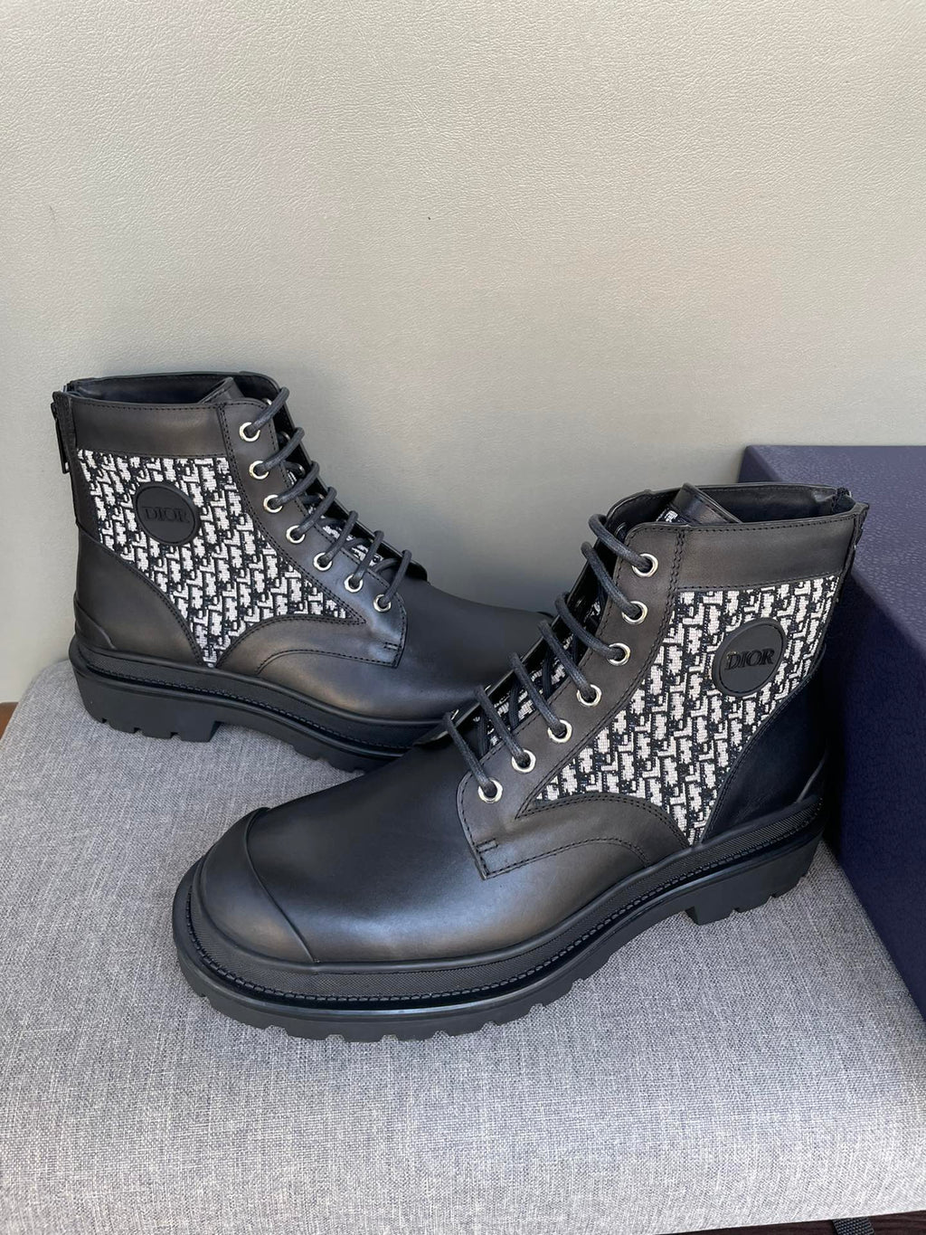Pair of Dior lace-up ankle boots with black leather and monogram knit uppers