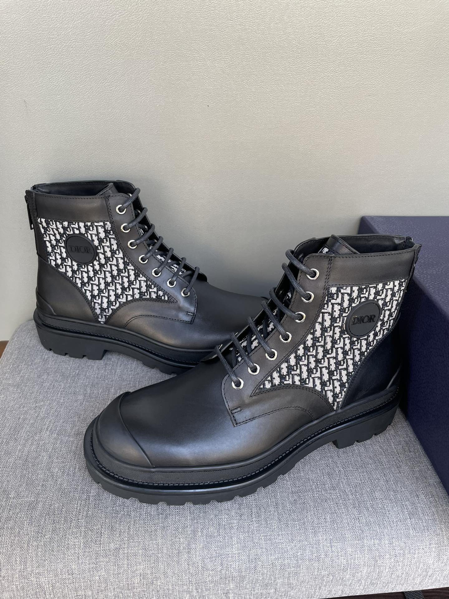 Pair of Dior lace-up ankle boots with black leather and monogram knit uppers