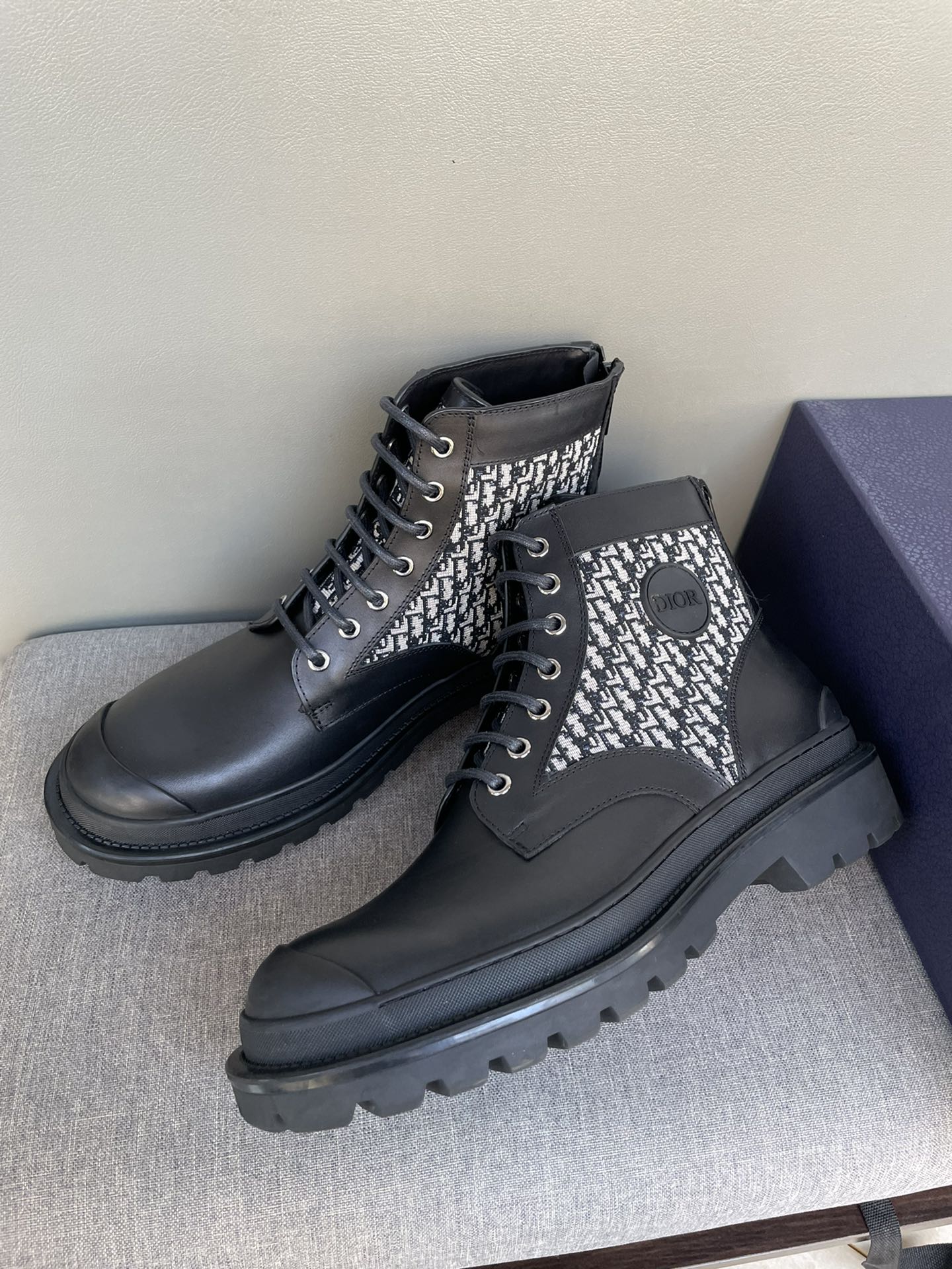 Pair of Dior lace-up ankle boots, black leather with monogram knit panels and laces