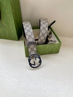 Gucci belt with GG monogram canvas strap and dark buckle, standing upright
