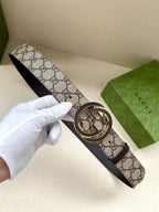 Gucci belt with GG monogram canvas strap and dark leather buckle detail
