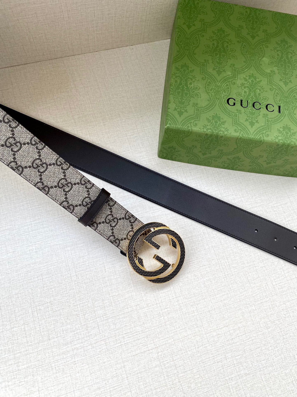Gucci belt strap with GG monogram pattern and round interlocking buckle
