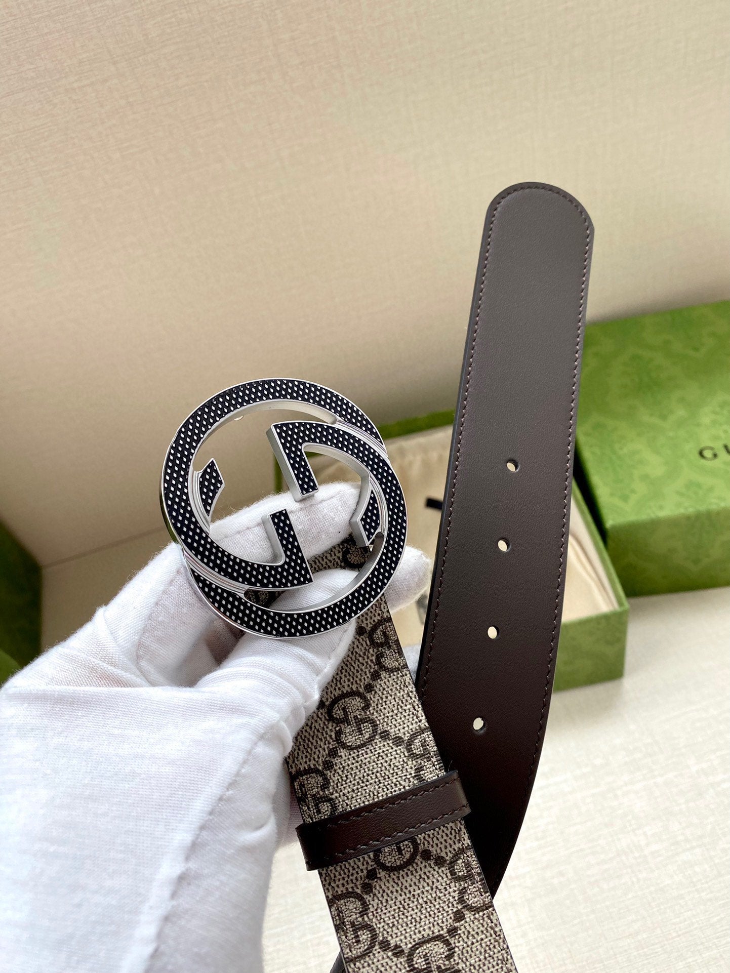 Gucci belt strap end with dark leather panel, GG monogram, and interlocking buckle