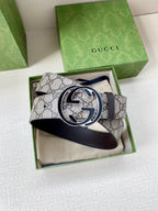 Gucci belt featuring GG monogram canvas and dark leather strap with large logo buckle