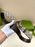 Gucci belt on dark leather base with GG canvas strap and gold-toned logo buckle