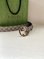 Gucci belt with GG monogram canvas strap and dark leather edge, gold-toned round buckle