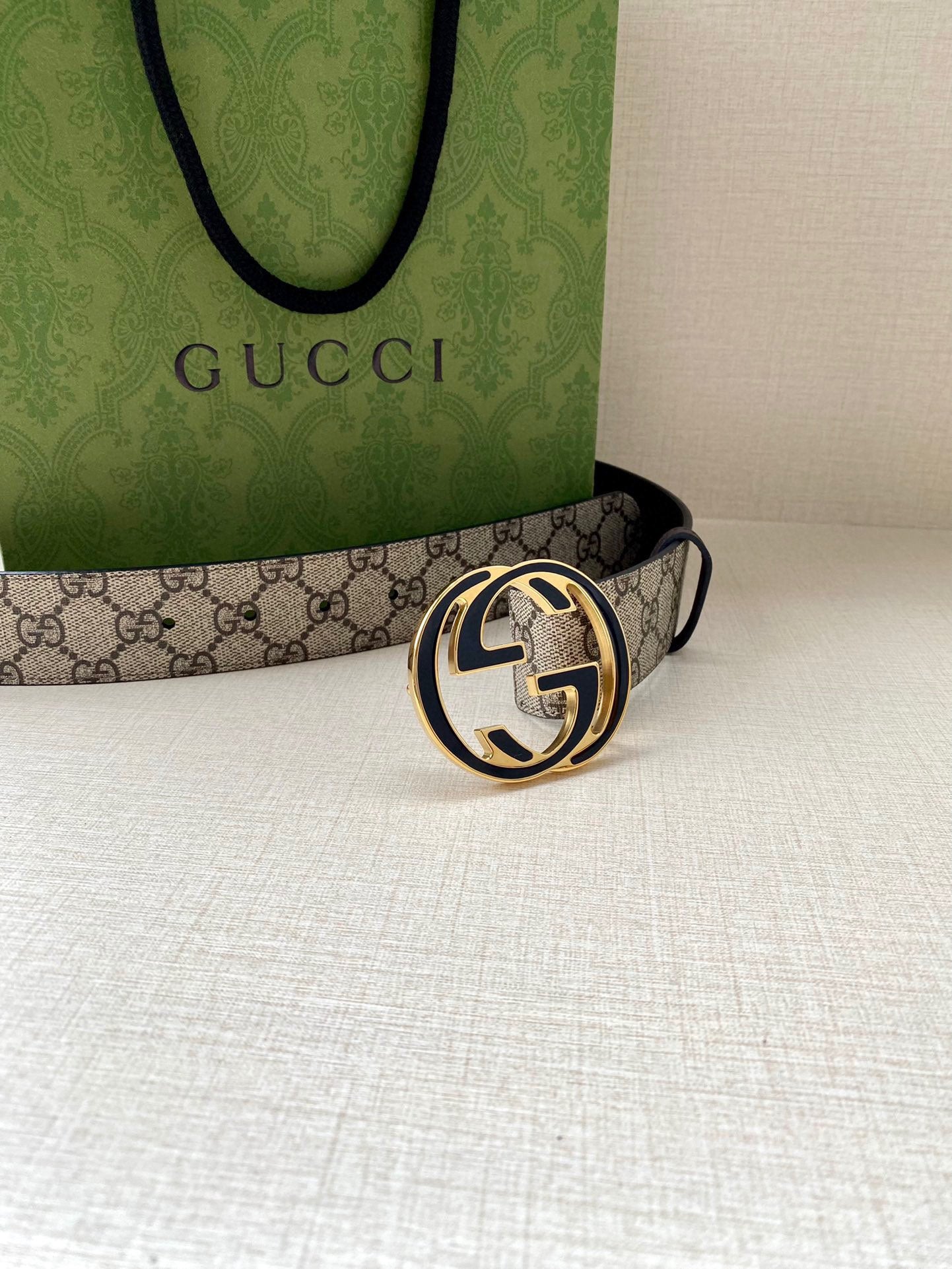 Gucci belt with GG monogram canvas strap and dark leather edge, gold-toned round buckle