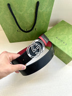 Gucci logo belt with round GG buckle, dark navy leather and red trim