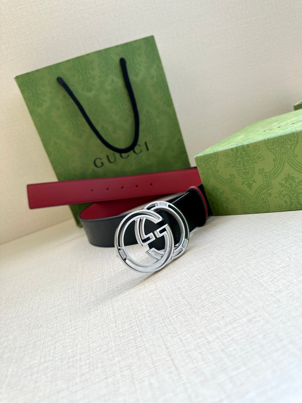 Gucci logo belt with round GG buckle, dark navy strap and red center section