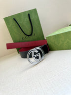 Gucci logo belt with round GG buckle, dark navy strap and red center section