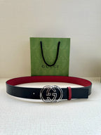 Gucci logo belt with round GG buckle, dark navy strap and red belt lining