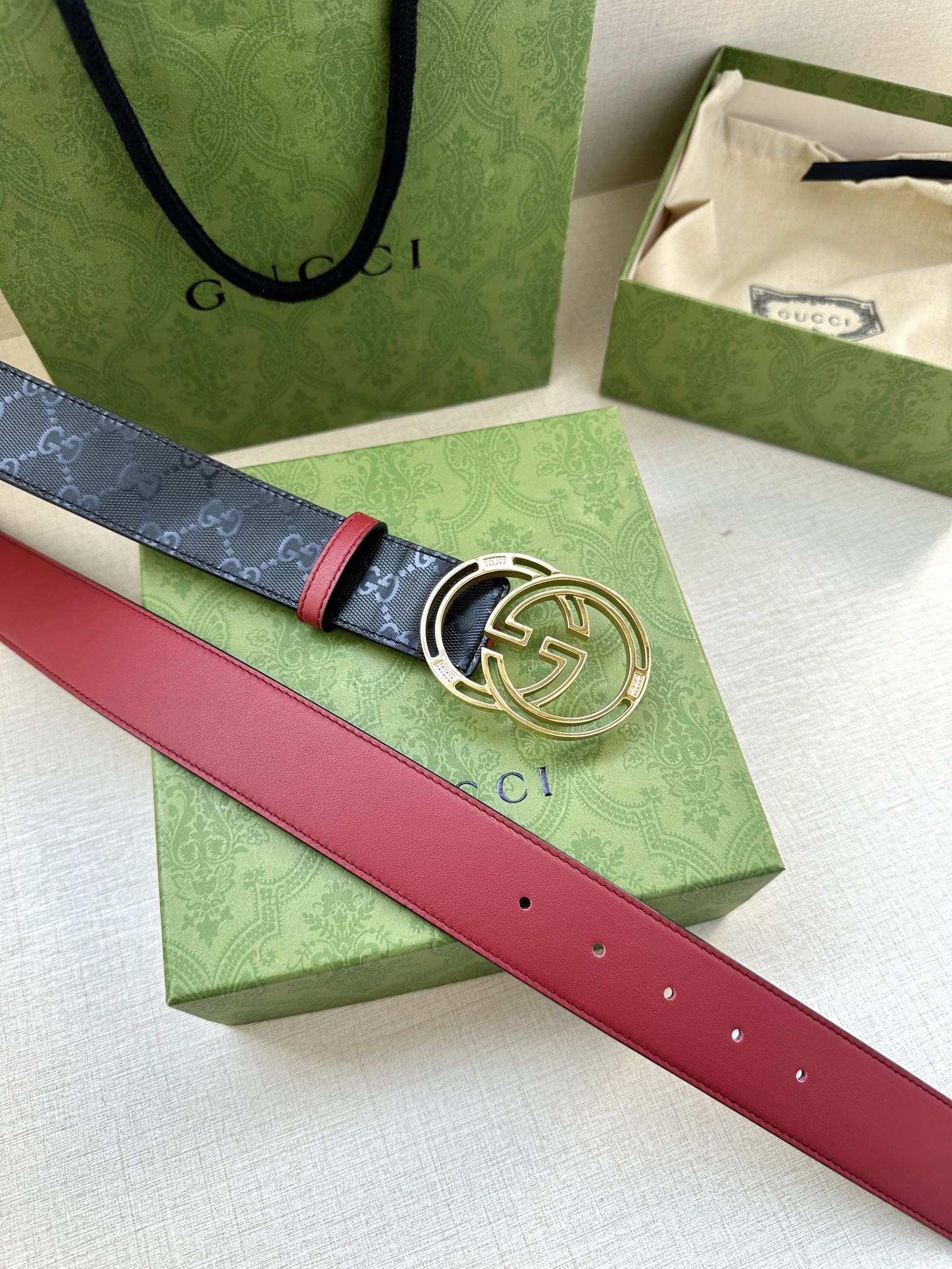 Gucci logo belt with round GG buckle, dark navy and red leather strap