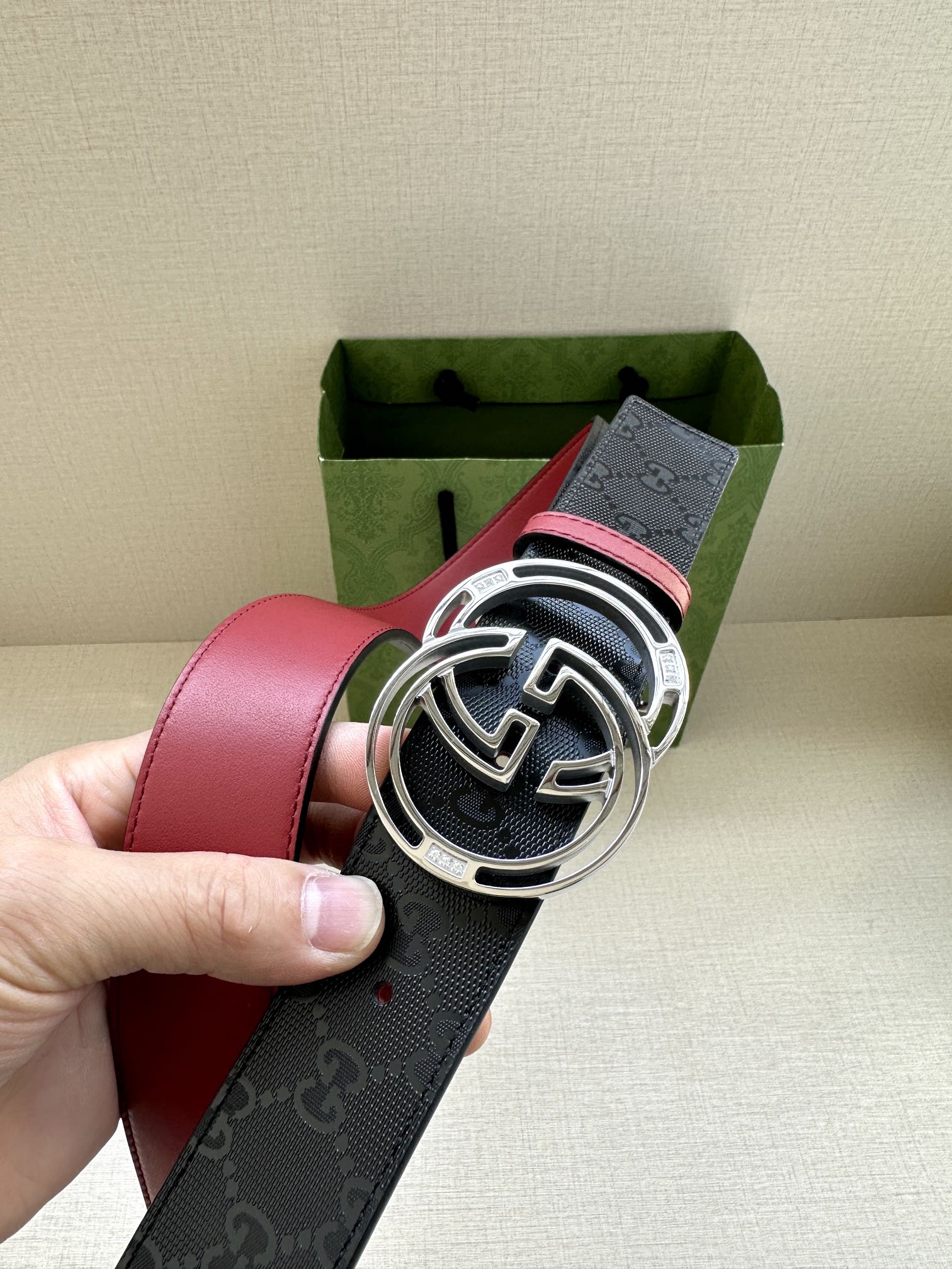 Gucci logo leather belt with large round GG buckle, dark navy and red strap