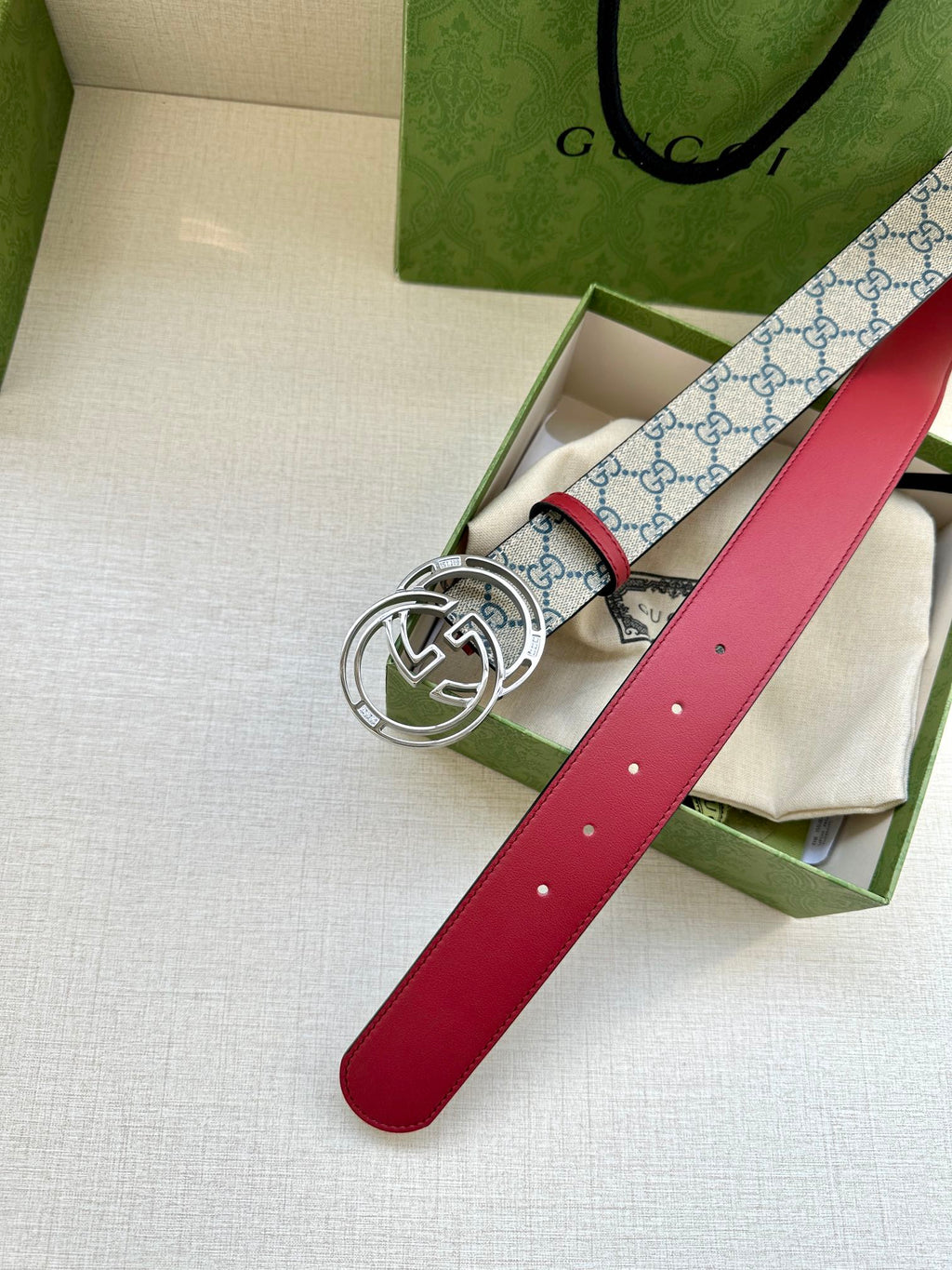 Gucci belt with red leather strap and blue GG canvas, silver-tone double-G buckle
