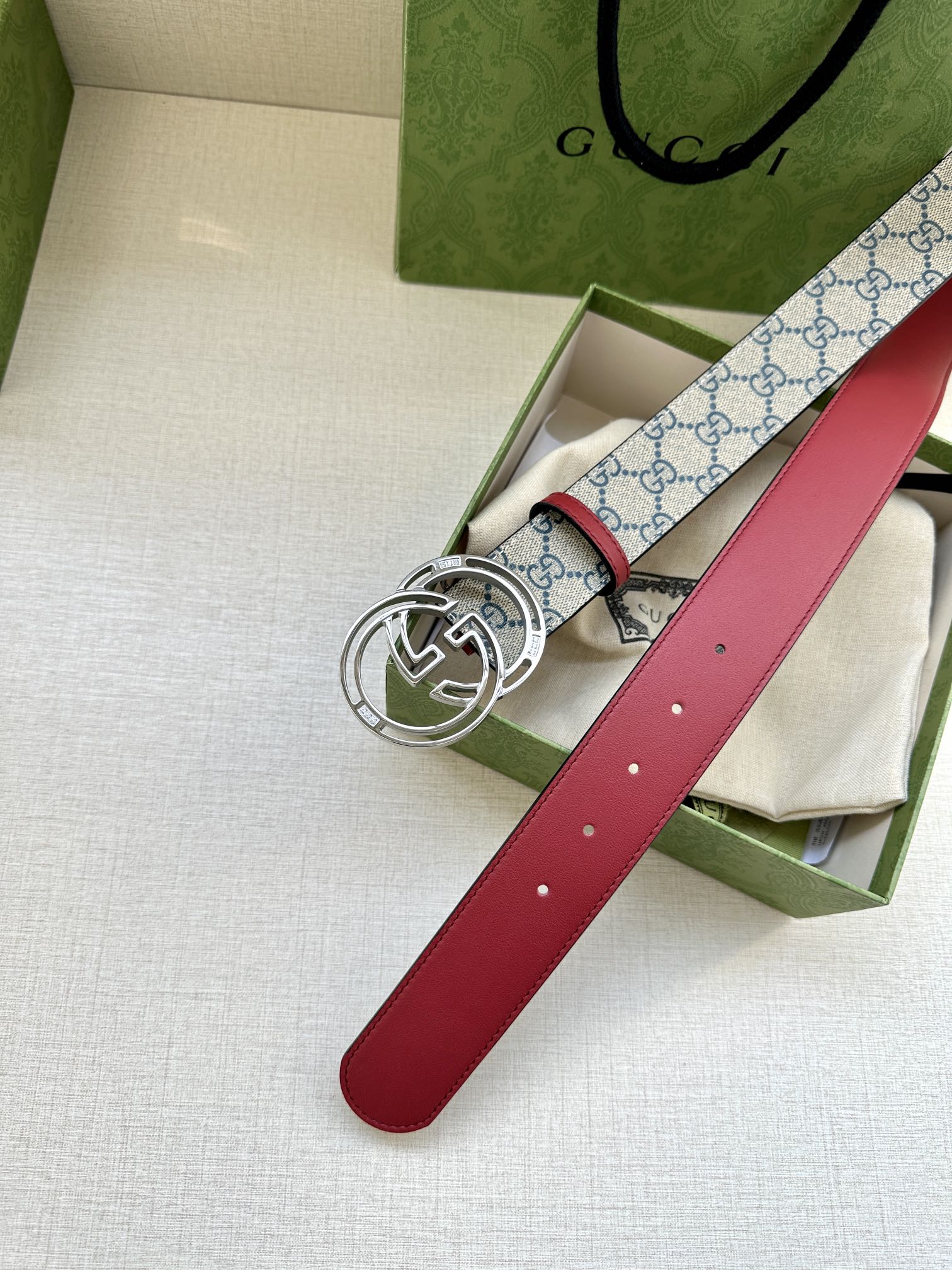 Gucci belt with red leather strap and blue GG canvas, silver-tone double-G buckle