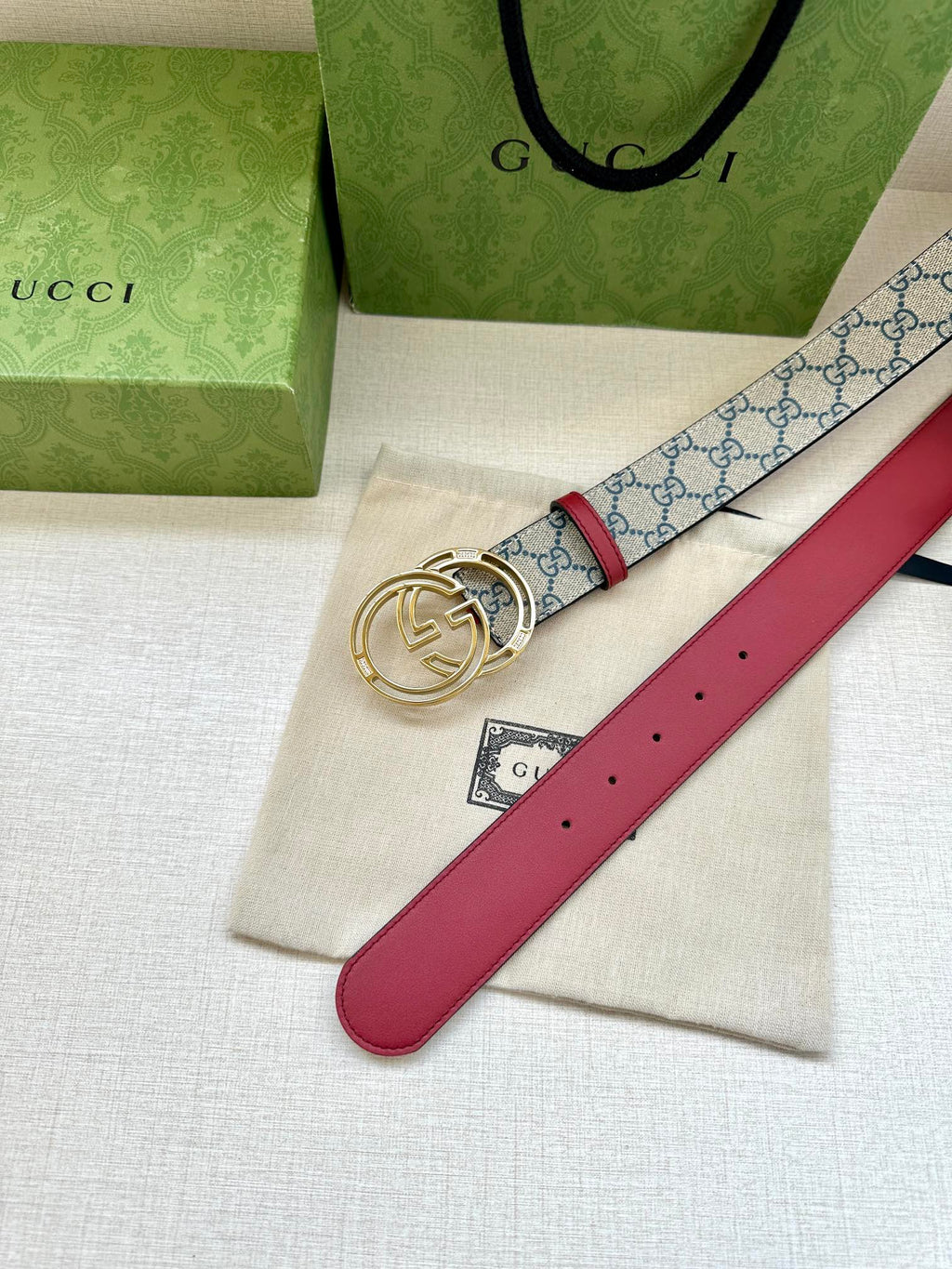 Gucci belt with red leather strap and blue GG canvas, gold-tone double-G buckle