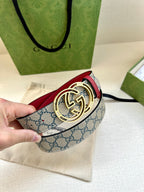 Gucci belt with blue GG canvas strap, red edge, and gold-tone double-G buckle