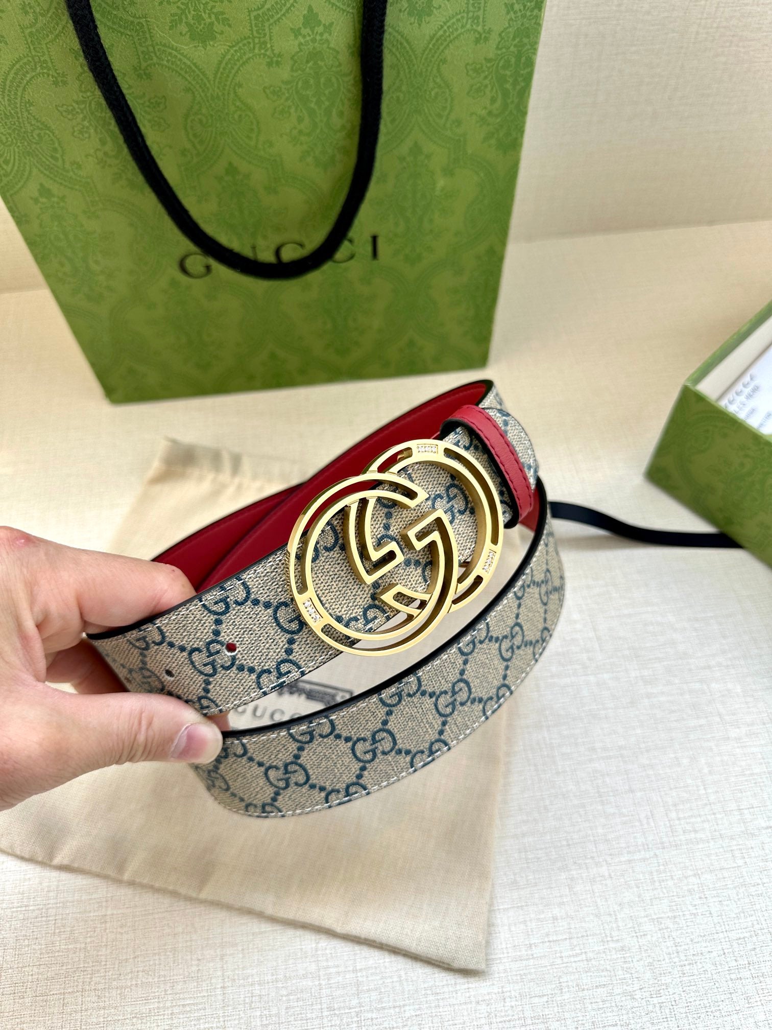 Gucci belt with blue GG canvas strap, red edge, and gold-tone double-G buckle