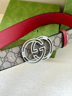 Gucci belt showing gray GG monogram strap, red leather trim, and large silver-tone GG buckle