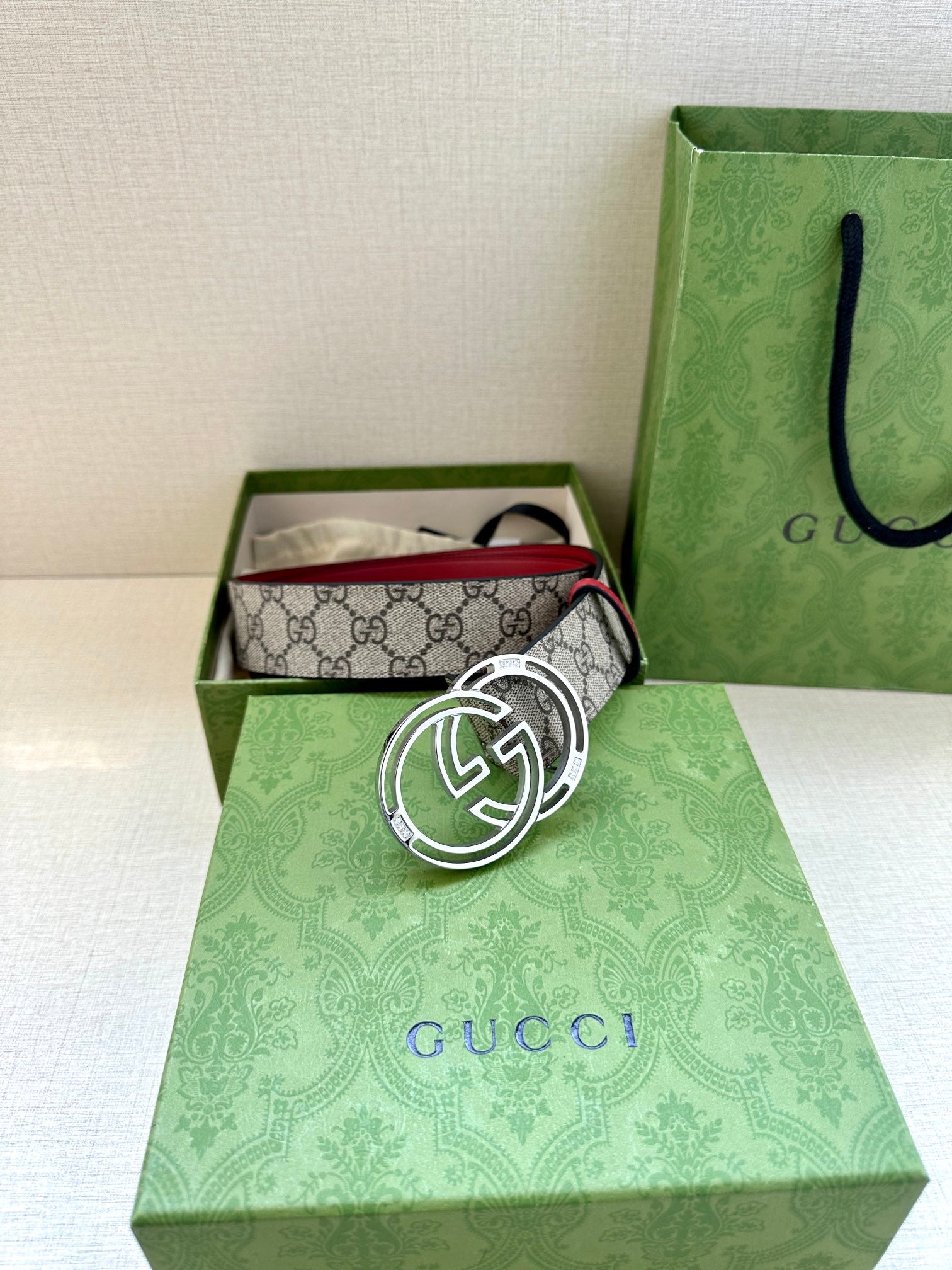 Gucci belt in box: gray GG monogram strap with red edge and silver-tone GG buckle
