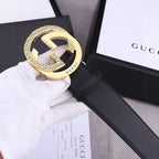Black leather belt with gold GG-style buckle and black strap with seam stitching