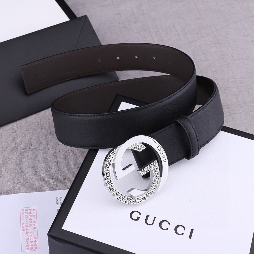 Black leather belt with silver-toned round buckle and smooth strap with keeper