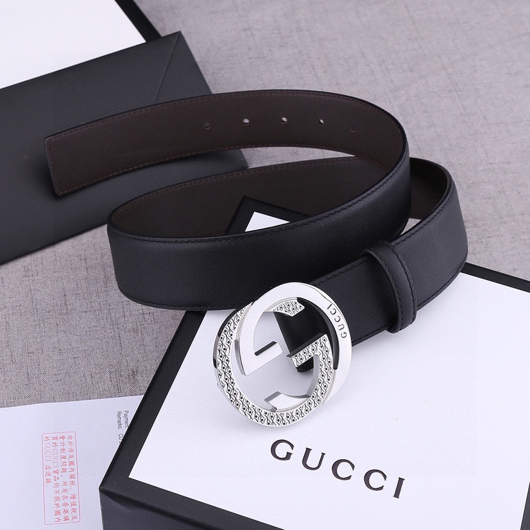 Black leather belt with silver-toned round buckle and smooth strap with keeper
