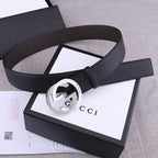 Black leather belt with silver-toned buckle, smooth strap and keeper at side