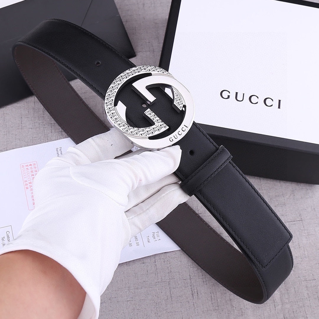 Black leather belt with silver-toned GG-style round buckle and stitched strap