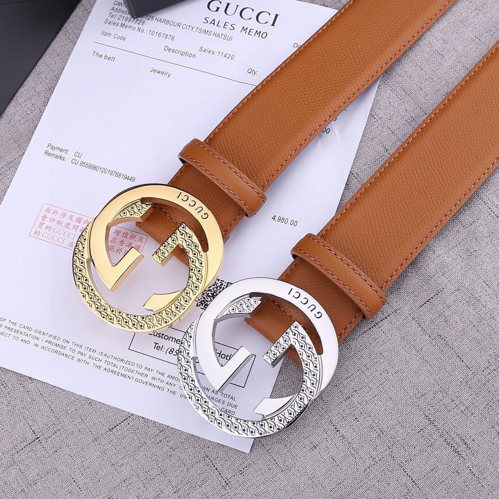 Tan leather Gucci belts with gold and silver round GG buckles on paperwork