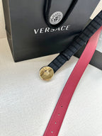 Versace belt with black grid strap and gold medallion buckle, red leather strap end