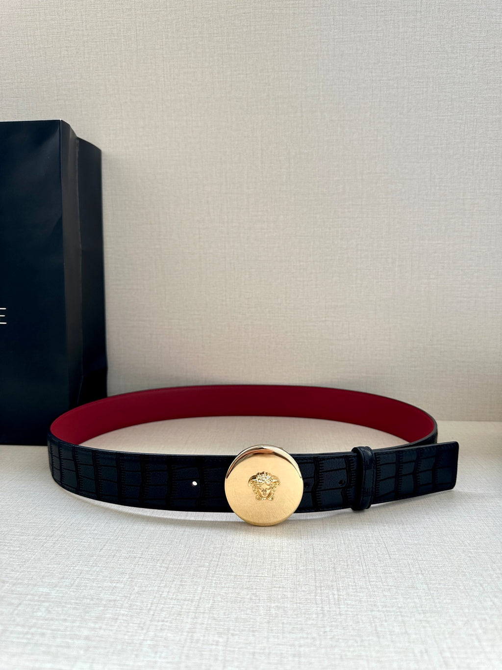 Versace belt with red inner edge, black grid strap and gold-tone medallion buckle
