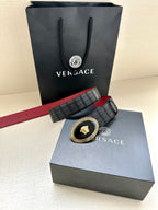 Versace belt with black textured strap and round gold medallion buckle