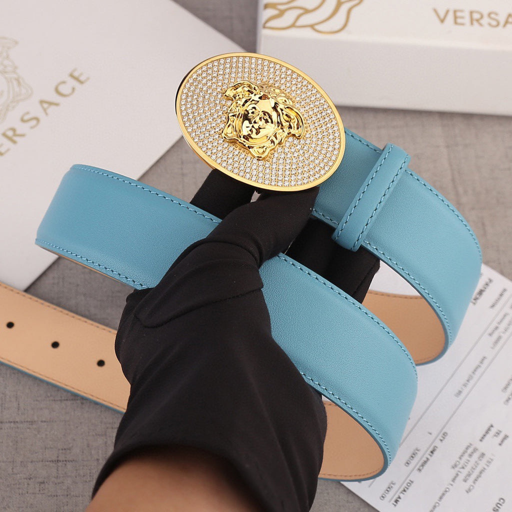 Light blue leather belt with round gold-tone medallion buckle and stitched belt strap