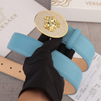 Light blue leather belt with round gold-tone medallion buckle and stitched belt strap