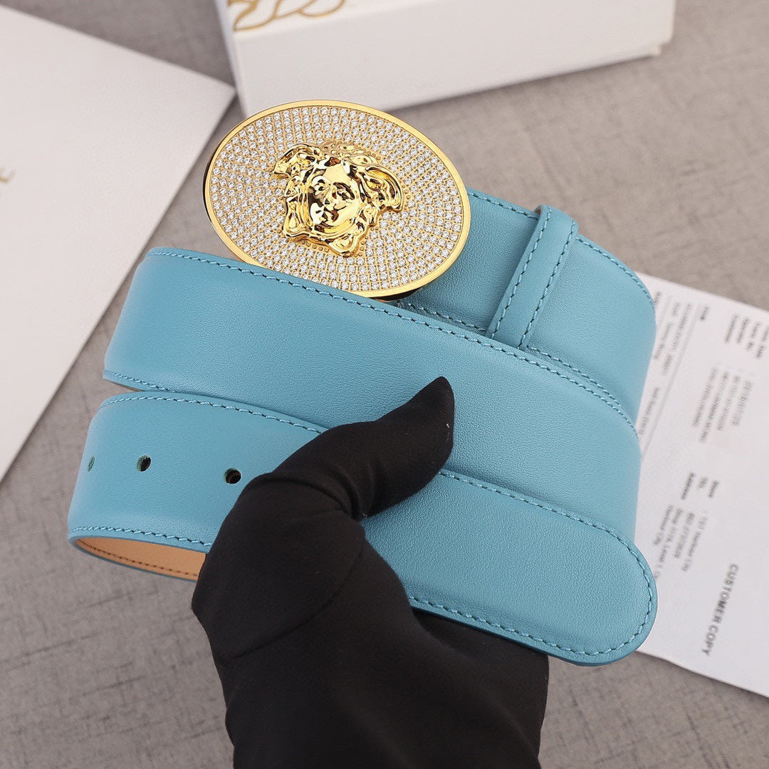 Light blue leather belt with gold-tone rhinestone medallion buckle and keeper holes