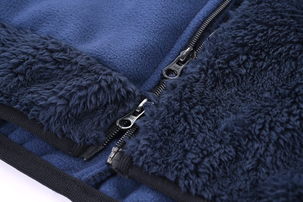 Fleece jacket with black zipper and stitched placket on blue panel