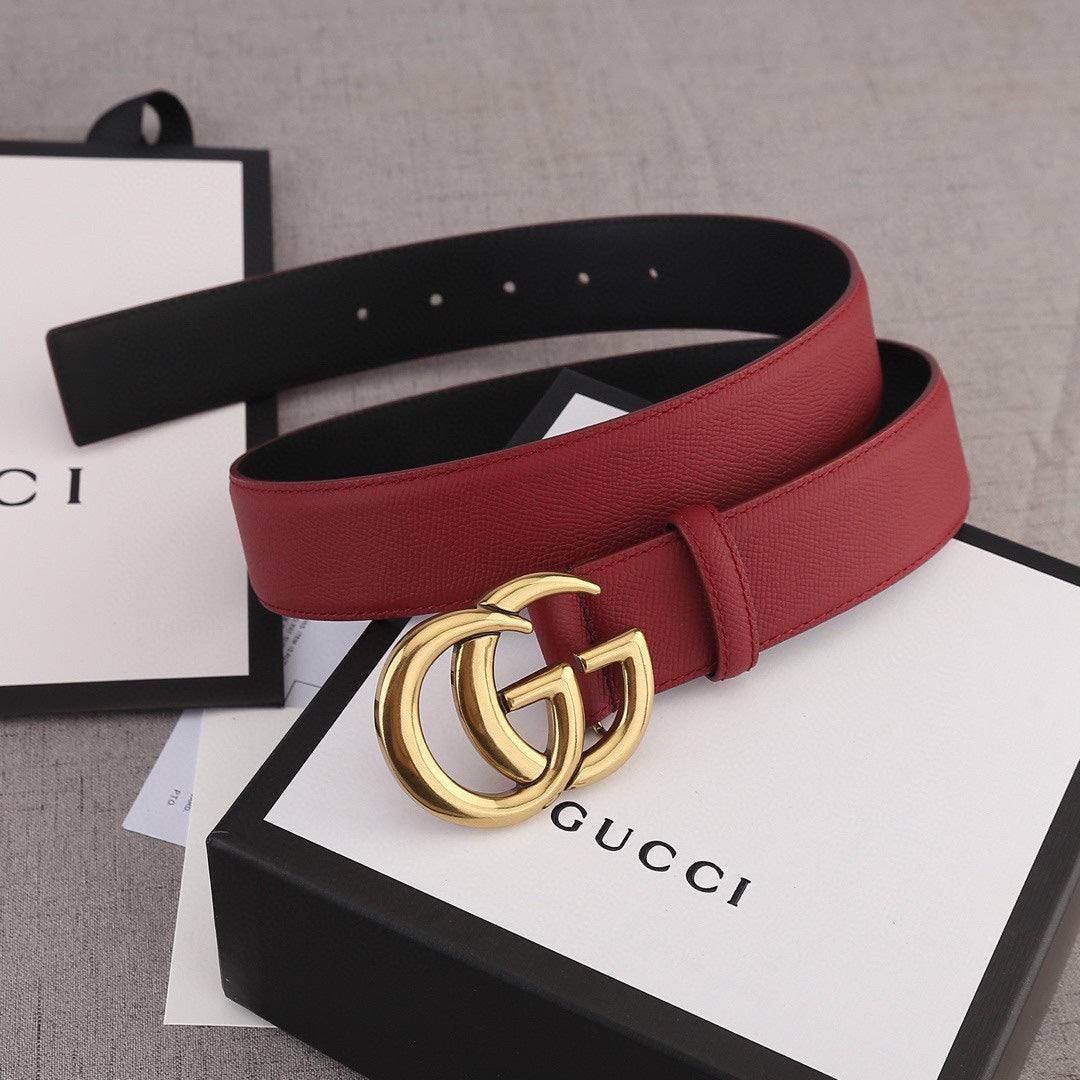 Red leather Gucci belt with gold double-G buckle and black inner strap