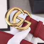 Red leather belt with large gold double-G buckle close-up